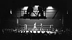 Photograph of camermen filming a boxing match