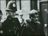 A protester being led away by police