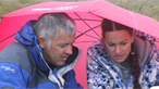 Derek and guide Becky Davies sheltering from the rain