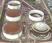 Aerial picture of the five storage tanks built to keep the gas chilled, with CGI showing the top of one