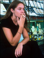 Girl smoking outside jewellery shop