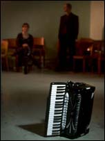 Picture of accordion and two tango dancers