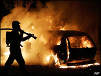 Bombeiro tenta apagar fogo de carro em chamas