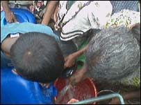 Tsunami displaced people waiting for water