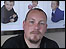 Man with goatee,  background pictures of children