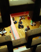 Class of adults practising yoga