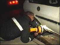 Chris examining a car