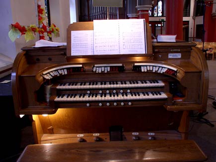 The keys of the Conacher organ, with sheet music in the holder ready to play