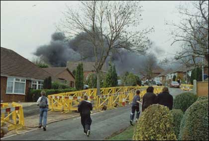 Children run towards a cloud of smoke