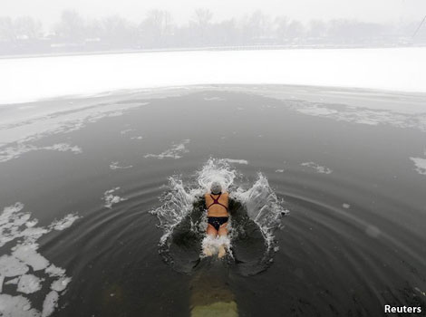 Swimmer plunging into a frozen lake