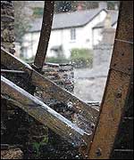 A cottage seen through waterwheel