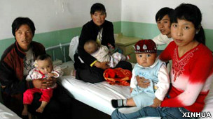 甘肃兰州某军医院内家长抱着患有肾结石的婴儿（新华社图片11/9/2008）