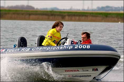 Boy driving a powerboat 470