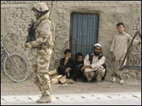 soldado da coalizão perto de civis afegãos