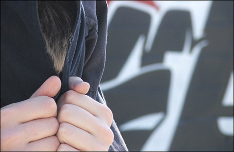 Man standing in front of graffiti