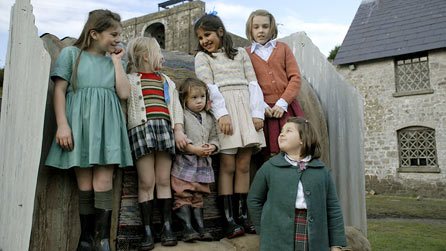 The children pose on the Anderson shelter