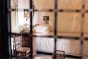 Pio's cell with simple bed and plain wooden chair. Photo credit: Delta X