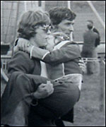 Man carrying fainting child