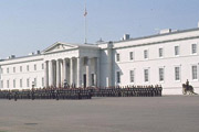 The academy at Sandhurst, a classical white building with troops parading outside