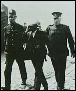 Protester being led away by police