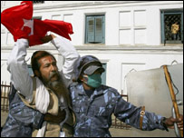 नेपाल में एक कार्यकर्ता को हिरासत में लेते सुरक्षाकर्मी