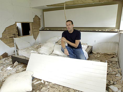 Ian Silverstein in the ruins of his house