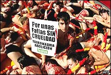 Anti-bullfighting demonstrators with banner and fake blood