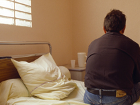 Library Image, Psychiatric patient sat on his bed 