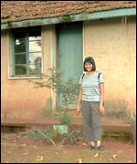 Mandy outside her old house in Uganda
