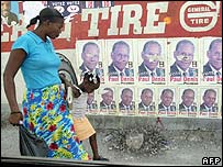 Haitiana passa por cartazes eleitorais em Porto Príncipe