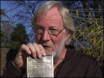 Will holding old letter from his father
