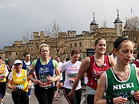 London Marathon runners pass the Tower of London
