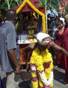 A man tows a cart attached to his back