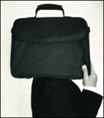 Man carrying briefcase on his shoulder