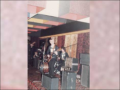 A band on stage in the 1980s.