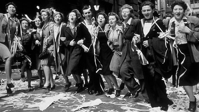 People dance in the streets of London on VE Day, 8 May 1945 