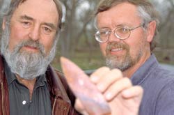 Dennis Stanford and Bruce Bradley with a Clovis spear point