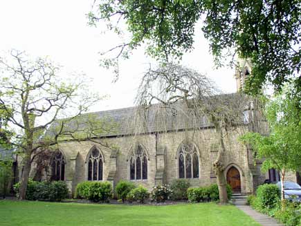 Emmanuel Church, a small stone church building surrounded by lawns and trees