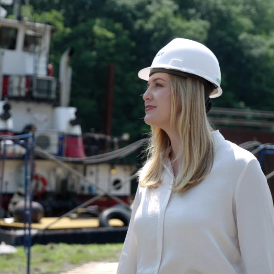 A woman wearing a white hard hat.