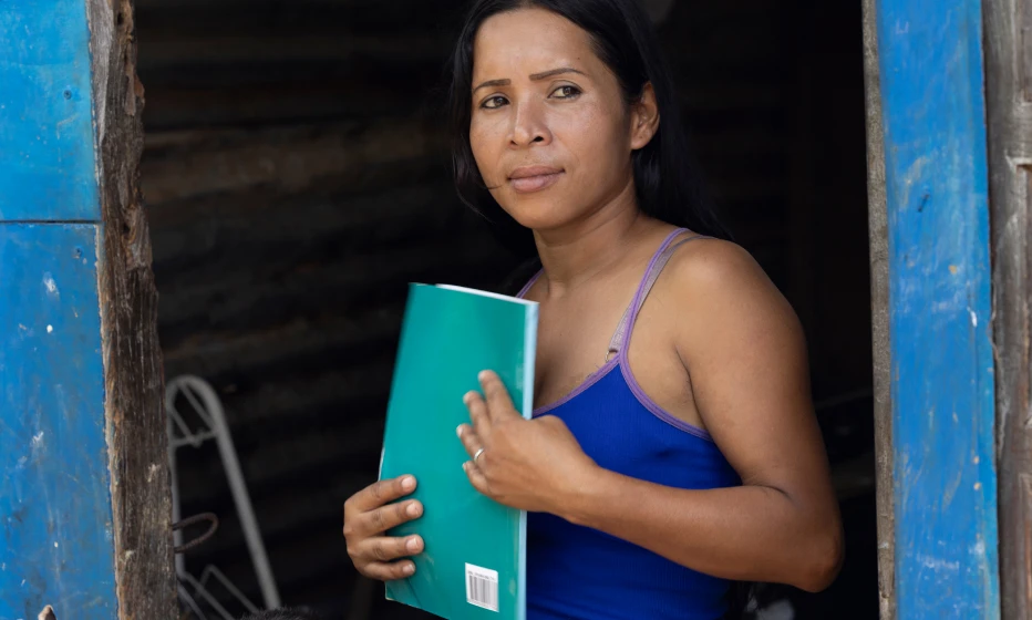 Woman looking out of a doorframe.
