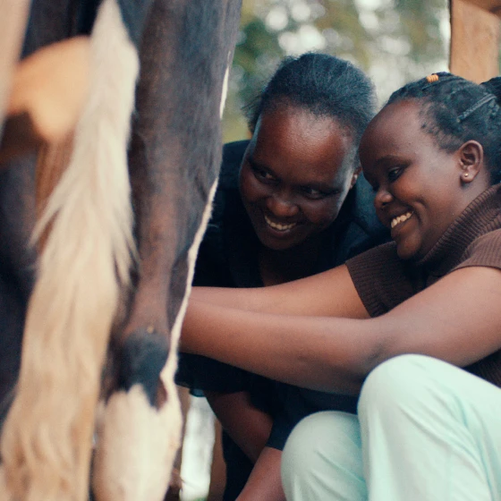 Two young women smiling.