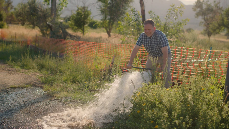 A man operating a water pump.