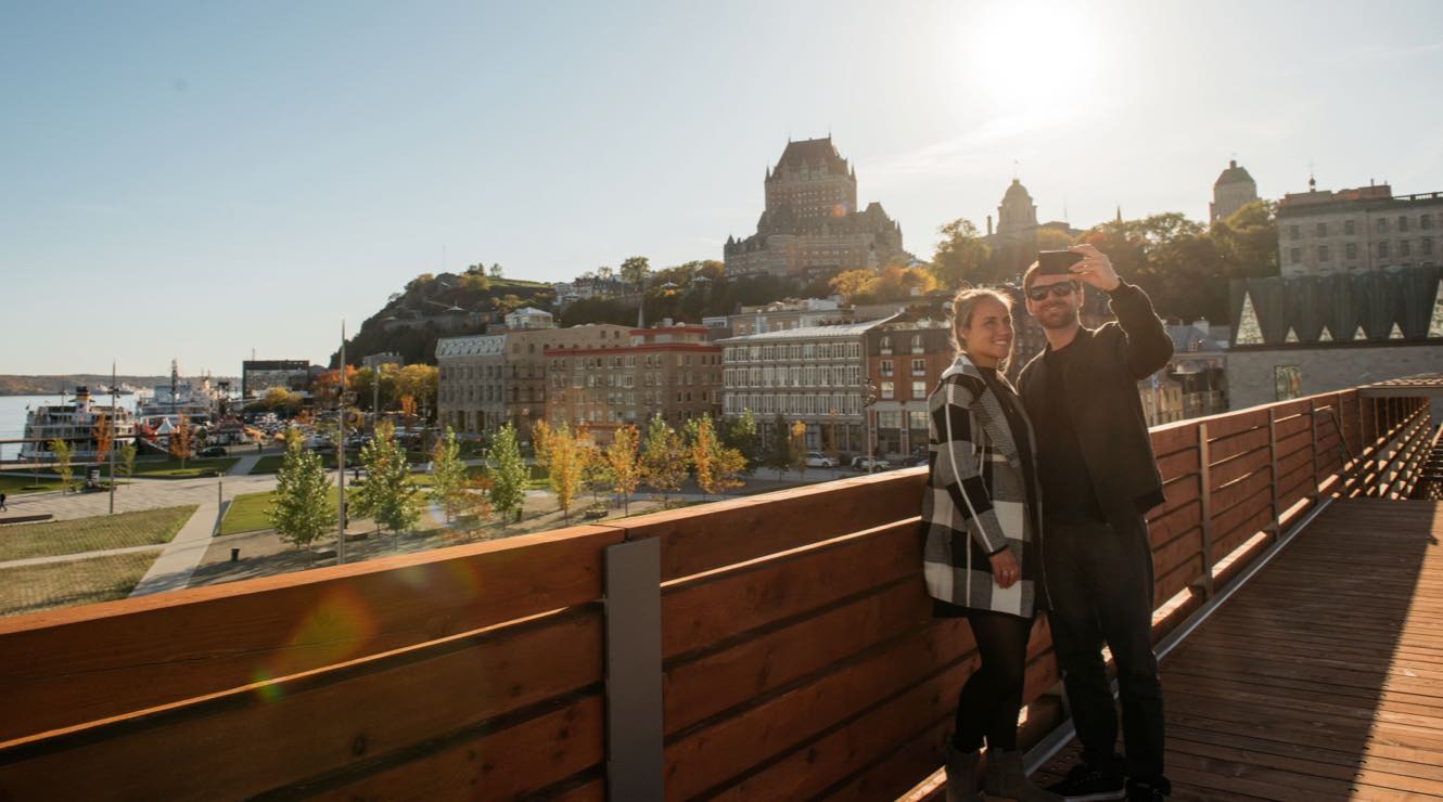 A couple taking a selfie with the city buildings