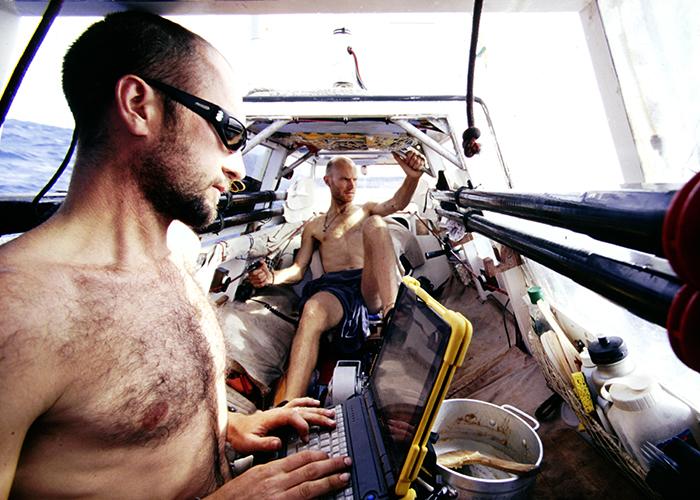 Smith pedals while Lewis updates their website, 1,000 miles west of the California coast en route to Hilo, Hawaii,1998.